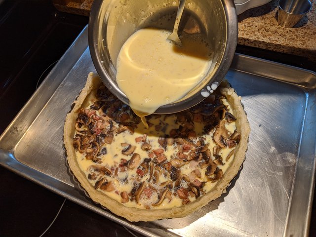 Pouring the eggs into the pastry